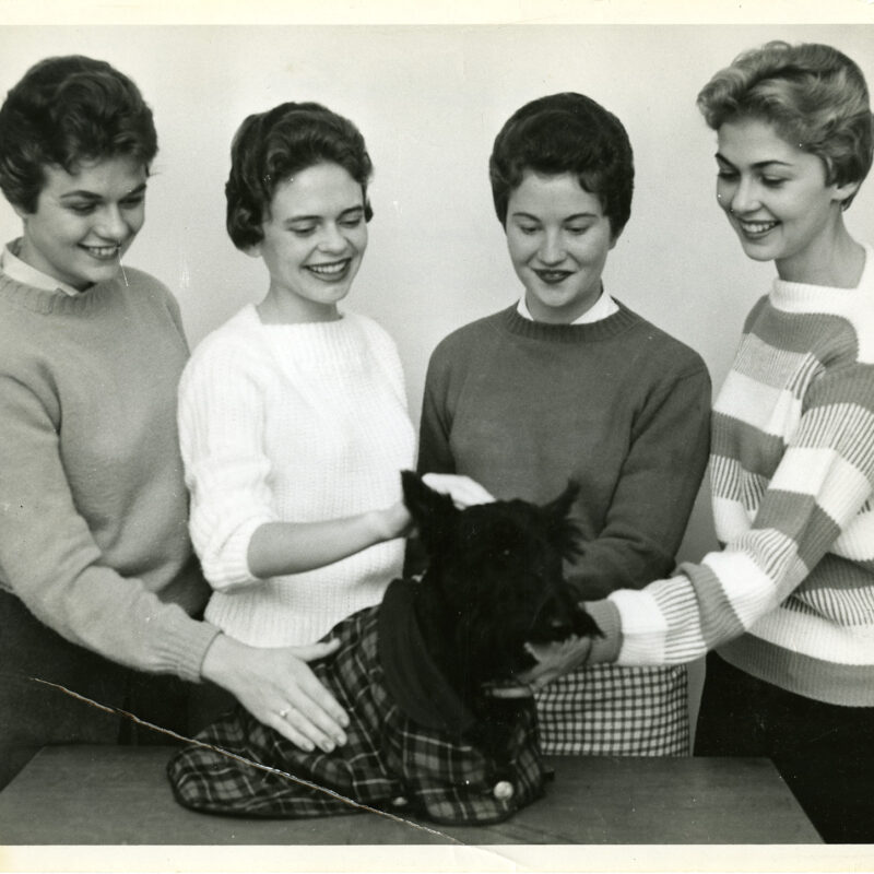 Class of 1960 classmates pose with Scottie dog (1958)